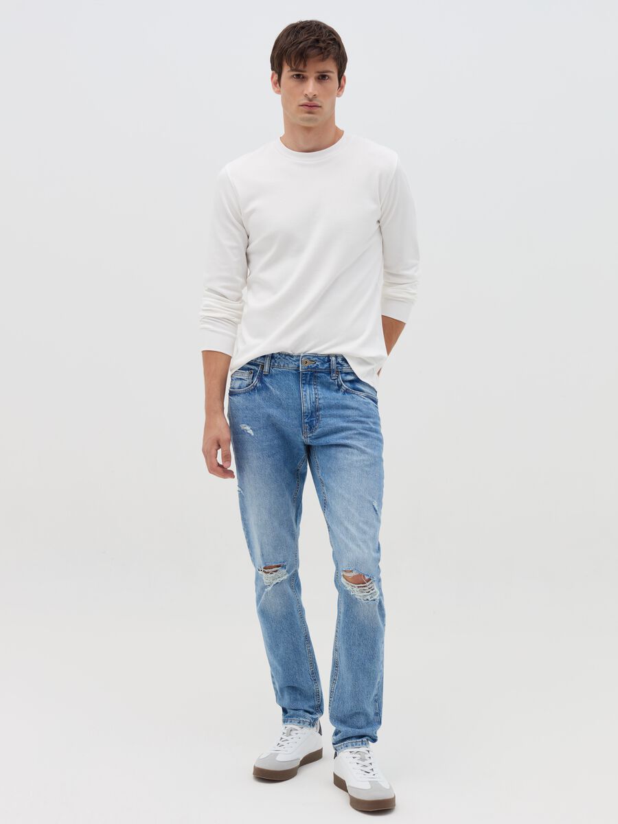 Slim-fit acid-wash jeans with abrasions_0