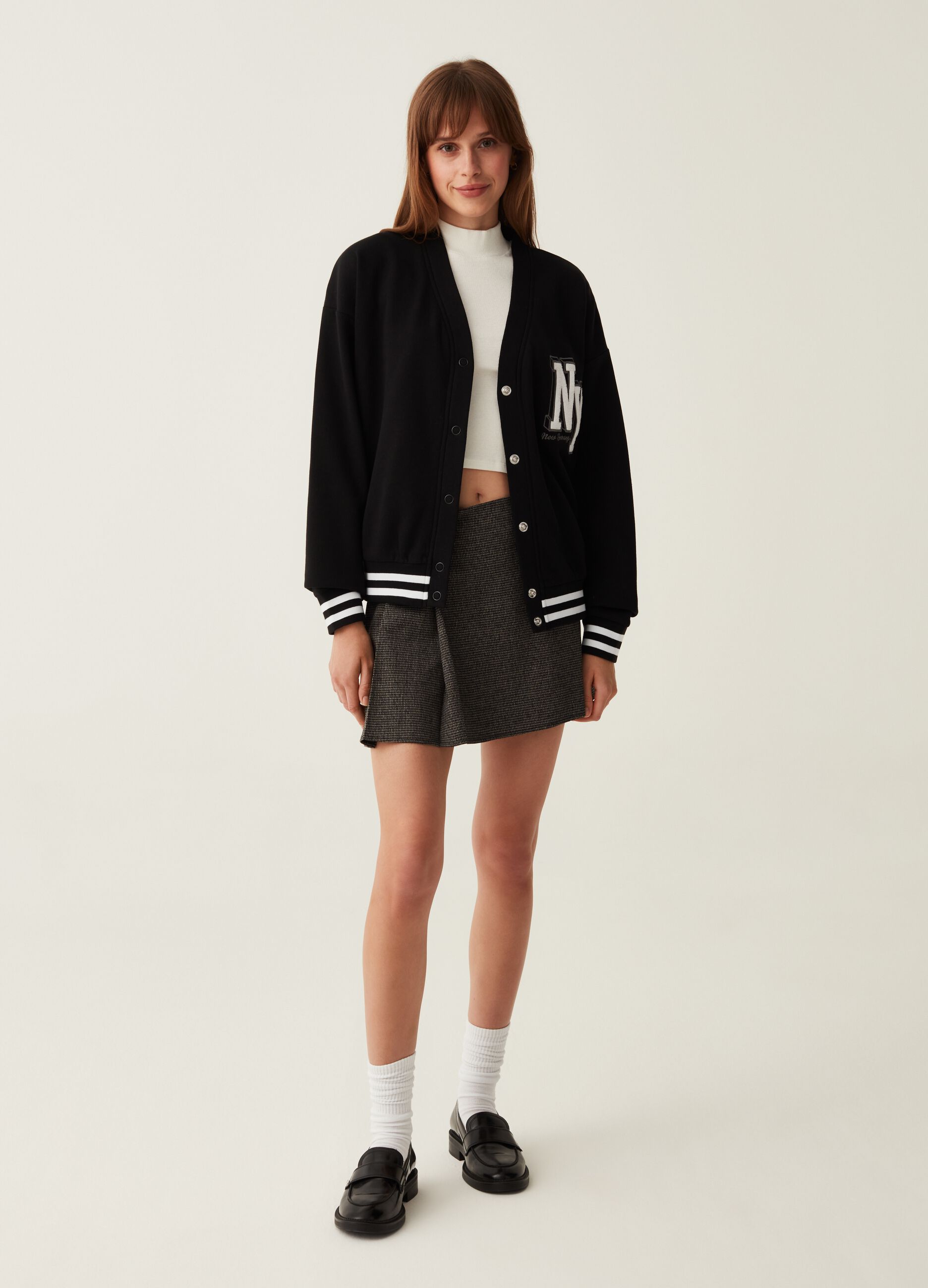 Varsity cardigan in plush with college emblem