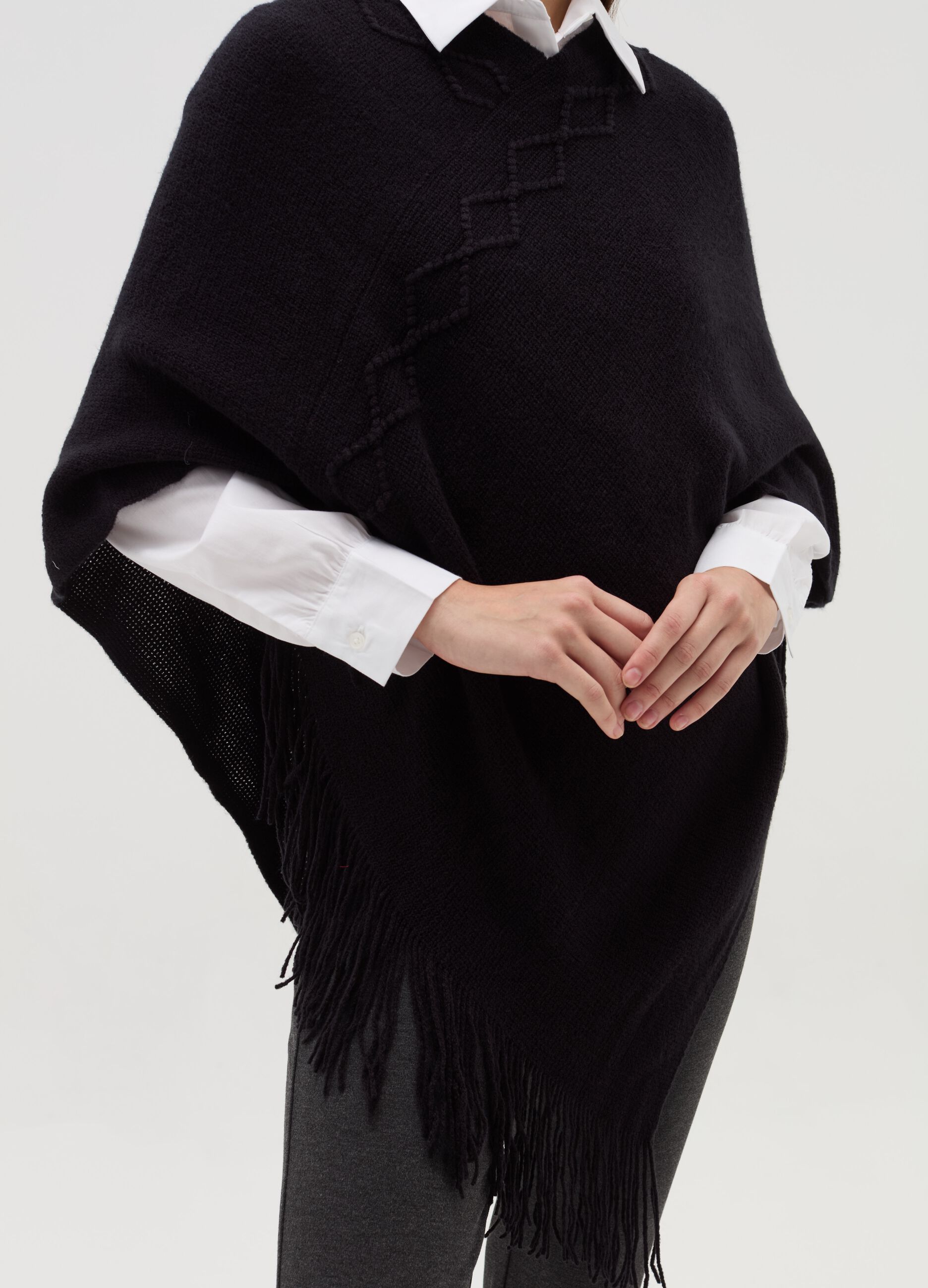 Poncho with diamond design and fringing