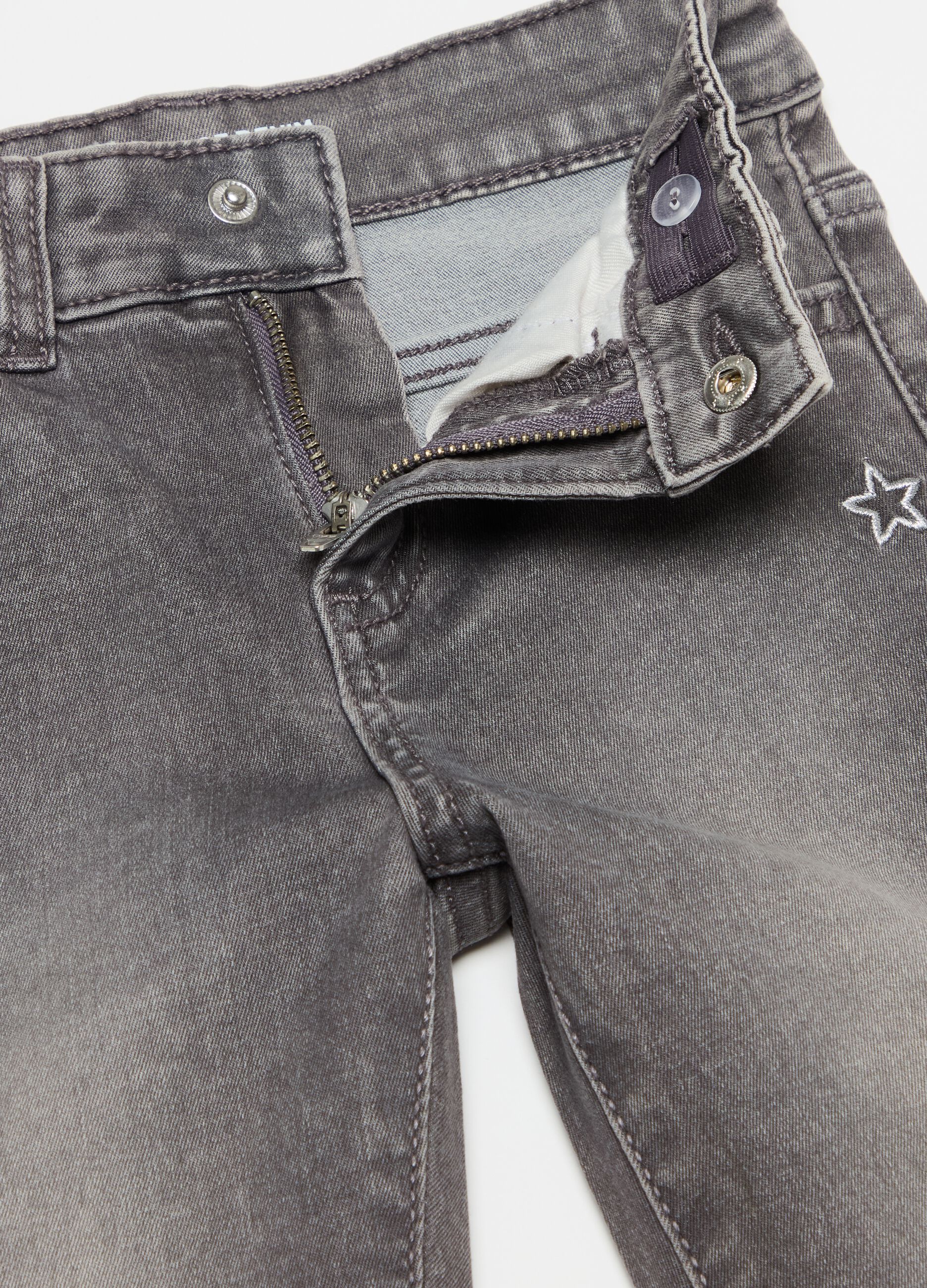 Jeans with five pockets and stars embroidery