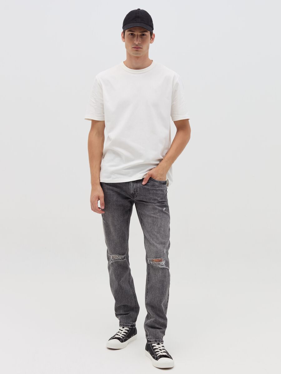 Slim-fit acid-wash jeans with abrasions_0