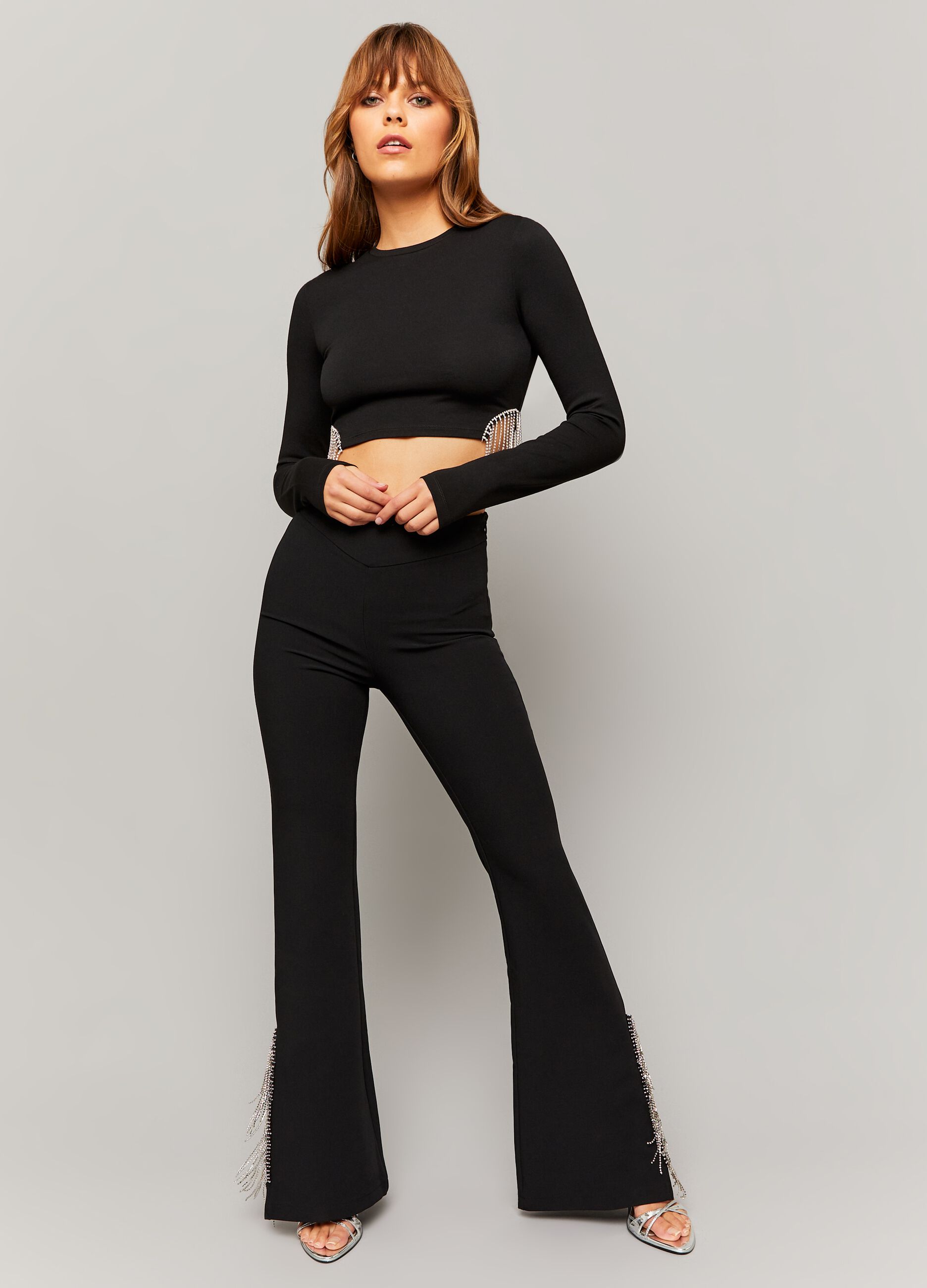 Flare-fit trousers with fringes in diamantés